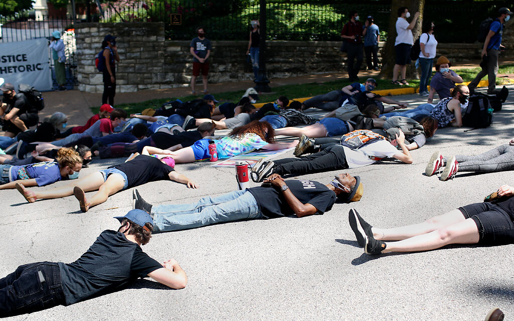 Protesters with the group Expect Us staged a die-in on Capitol Avenue